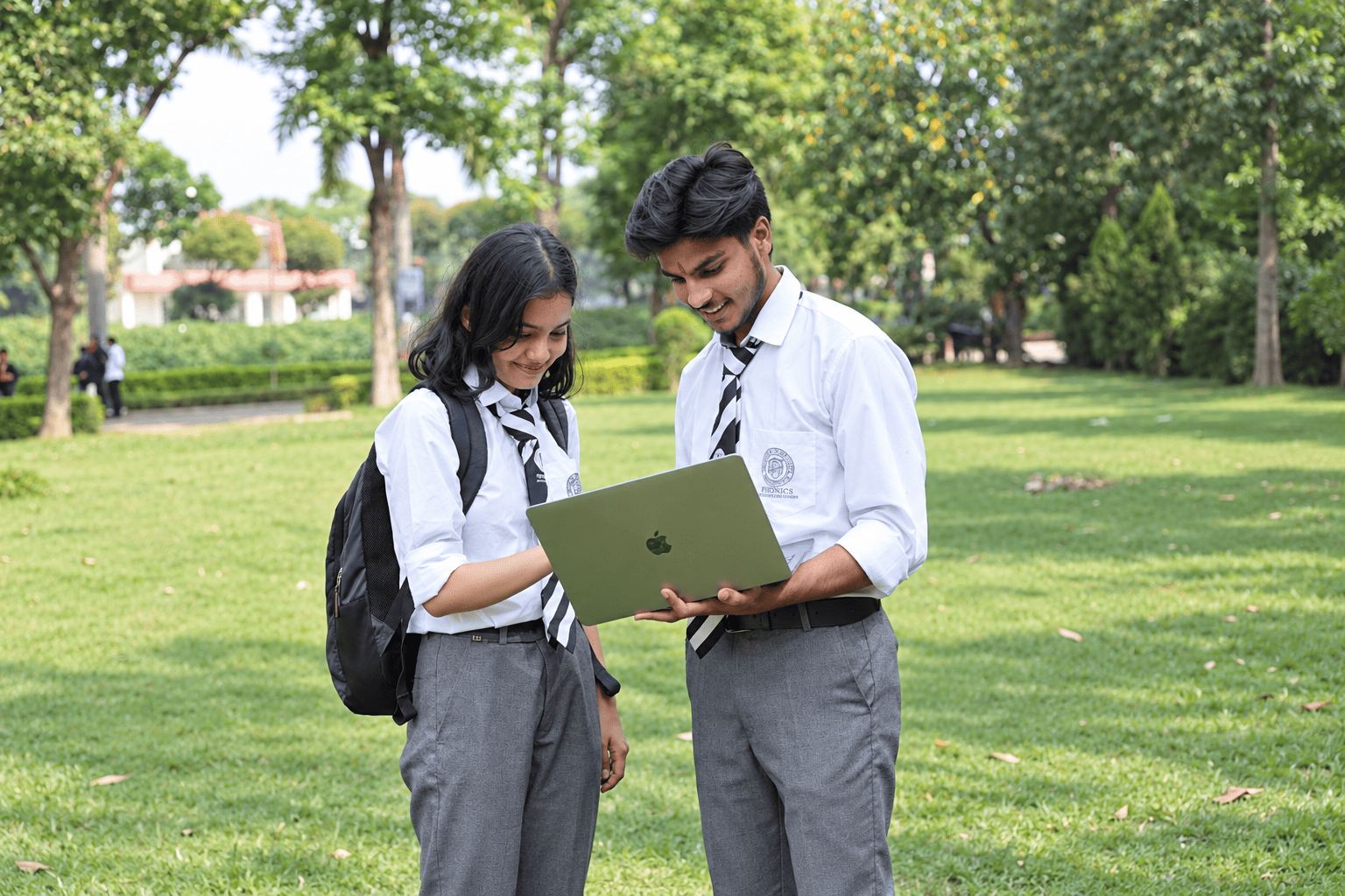 Students working together on campus lawn